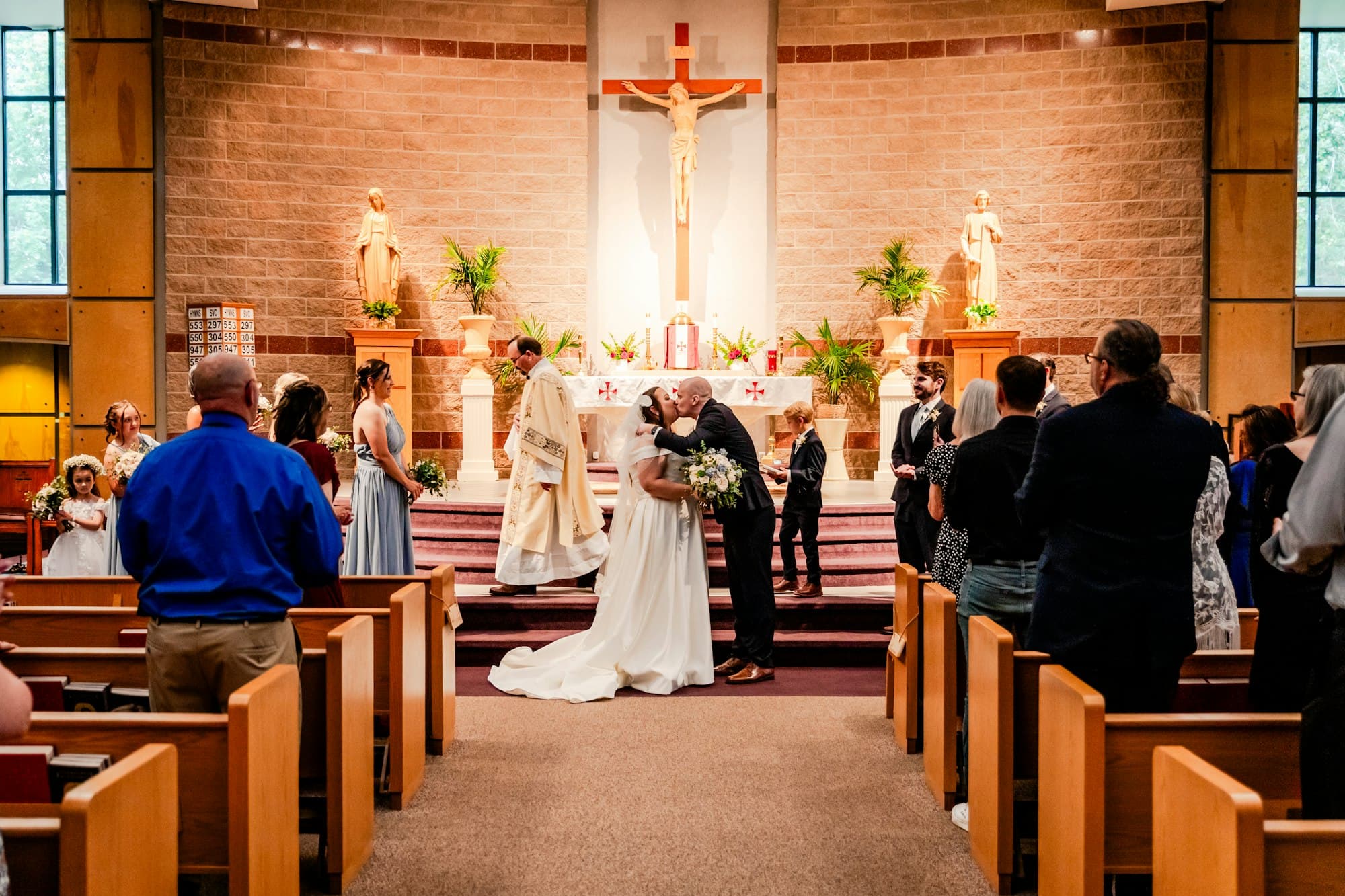A bride and groom exchange vows at a parish altar