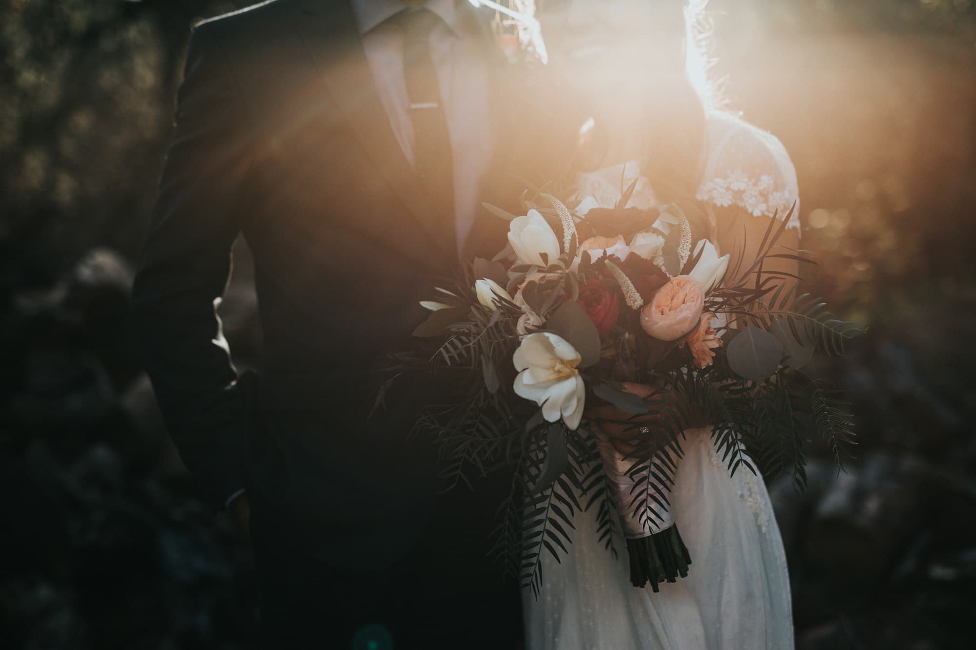 A bride holds her bouquet beside the groom