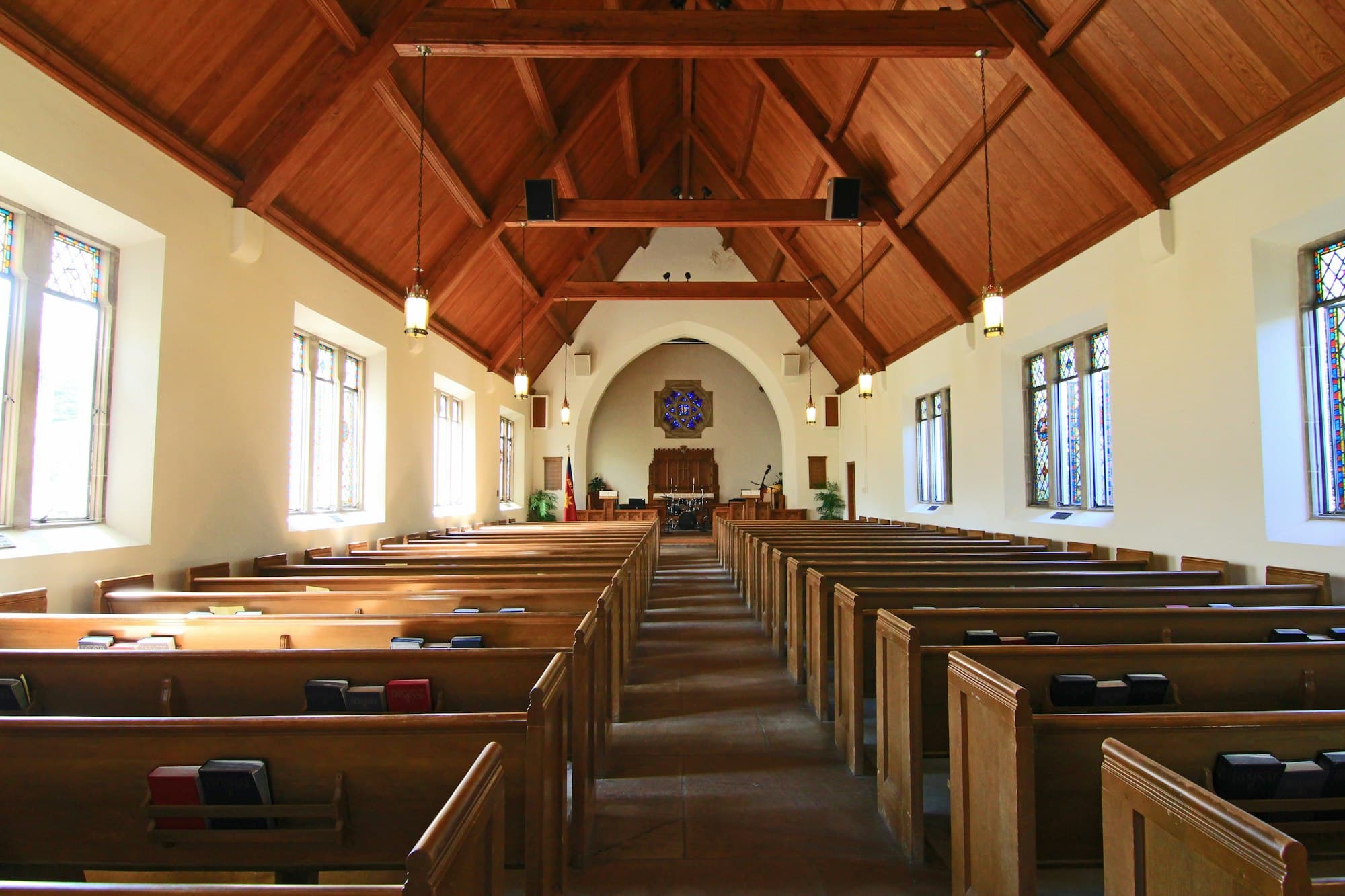 Warm light falls across the pews of a quiet church