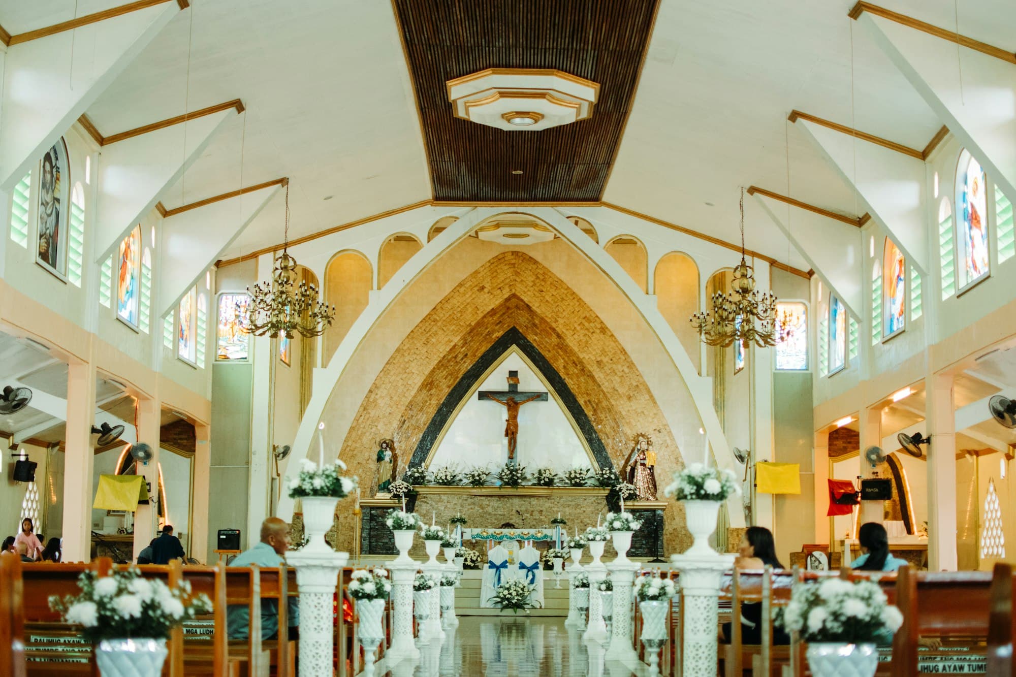 Sunlit parish church interior with guests in the pews