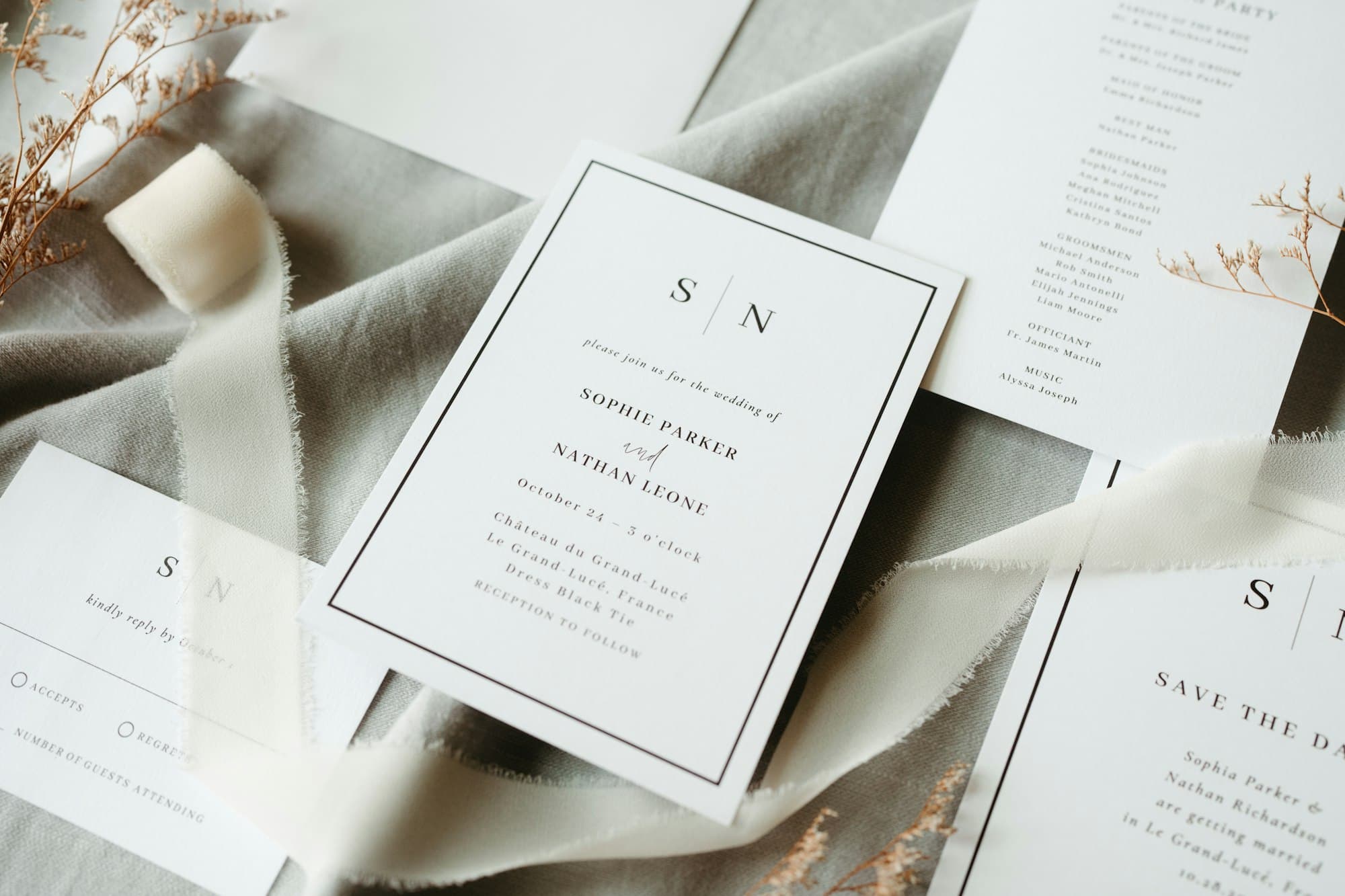 A wedding invitation suite arranged on draped fabric